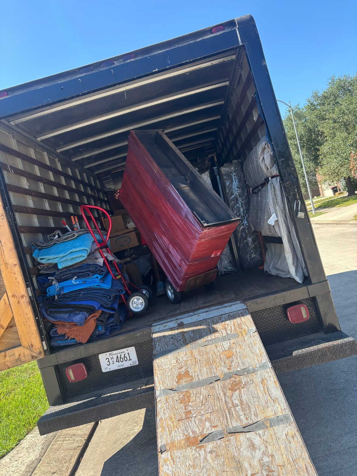 Shrink-wrapped furniture and moving blankets loaded in a truck