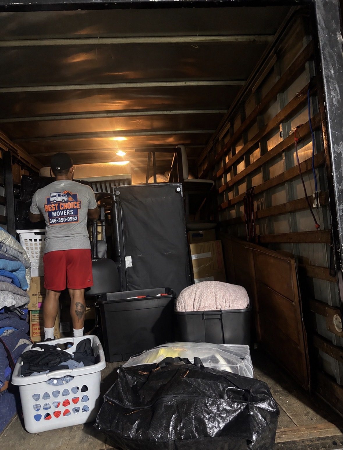Best Choice Movers crew member loading office chairs into a truck